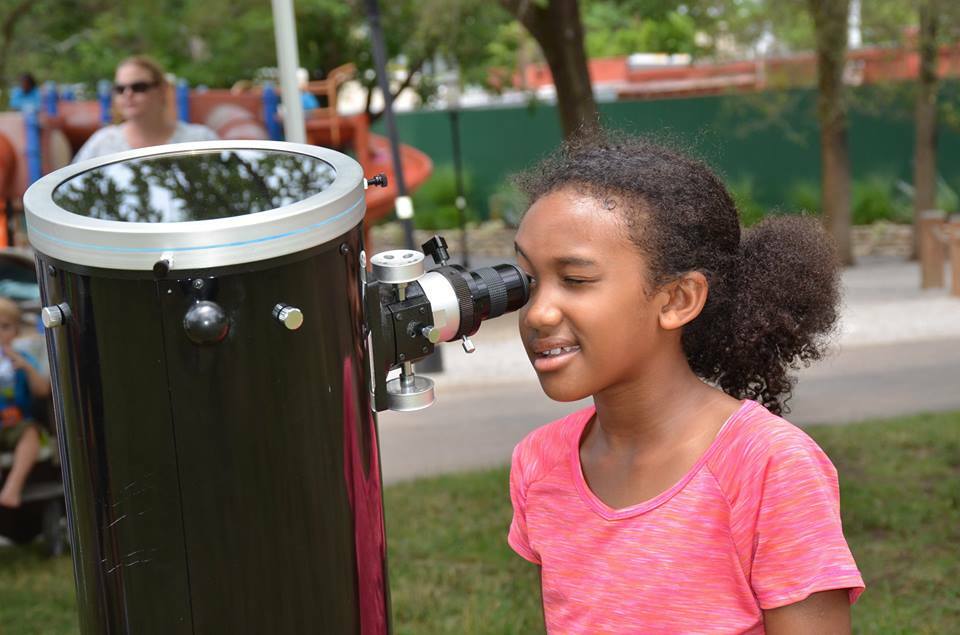 Student looking through a telescope